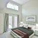 1st floor master bedroom has volume ceilings, a ceiling fan, WIC & access to the rear yard/patio.