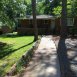 Front of house with yard, porch and parking area to the side