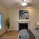 First floor bedroom has a ceiling fan & adjacent bath.