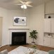 Family room has volume ceilings, a ceiling fan, built ins, wood floors and a fireplace.
